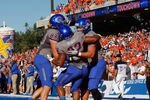 BOISE, ID - OCTOBER 22:  Gabe Linehan #87, Doug Martin #22, and Chandler Koch #88 of the Boise State Broncos celebrate Martin's touchdown against the Air Force Falcons at Bronco Stadium on October 22, 2011 in Boise, Idaho.  (Photo by Otto Kitsinger III/Getty Images)