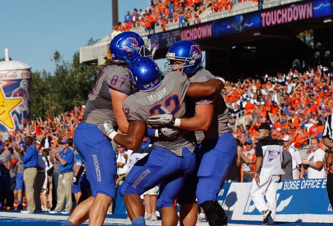 BOISE, ID - OCTOBER 22:  Gabe Linehan #87, Doug Martin #22, and Chandler Koch #88 of the Boise State Broncos celebrate Martin's touchdown against the Air Force Falcons at Bronco Stadium on October 22, 2011 in Boise, Idaho.  (Photo by Otto Kitsinger III/Getty Images)