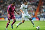 MADRID, SPAIN - OCTOBER 18:  Mesut Ozil (R) of Real Madrid shields Jimmy Briand of Olympique Lyonnais from the ball during the UEFA Champions League group D match between Real Madrid and Olympique Lyonnais at the Estadio Santiago Bernabeu on October 18, 2011 in Madrid, Spain.  (Photo by Jasper Juinen/Getty Images)