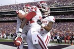 MANHATTAN, KS - OCTOBER 29:  Dejuan Miller #24 of the Oklahoma Sooners celebrates a 11-yard touch pass with teammates in the first quarter during a game against Kansas State at Bill Snyder Family Stadium on October 29, 2011 in Manhattan, Kansas. (Photo by Ed Zurga/Getty Images)
