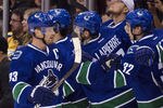 VANCOUVER, CANADA - OCTOBER 20: Henrik Sedin #33 of the Vancouver Canucks is congratulated by teammates Maxim Lapierre #40 and Dale Weise #32 after scoring against the Nashville Predators during the first period in NHL action on October 20, 2011 at Rogers Arena in Vancouver, British Columbia, Canada.  (Photo by Rich Lam/Getty Images)