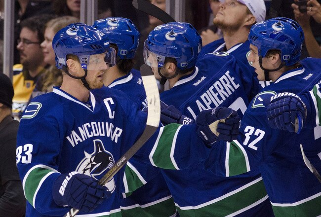 VANCOUVER, CANADA - OCTOBER 20: Henrik Sedin #33 of the Vancouver Canucks is congratulated by teammates Maxim Lapierre #40 and Dale Weise #32 after scoring against the Nashville Predators during the first period in NHL action on October 20, 2011 at Rogers Arena in Vancouver, British Columbia, Canada.  (Photo by Rich Lam/Getty Images)