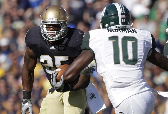 SOUTH BEND, IN - SEPTEMBER 17:  Jonas Gray #25 of the Notre Dame Fighting Irish rushes on Andrew Maxwell  #10  the Michigan State Spartans during the first half September 17, 2011at Notre Dame Stadium in South Bend, Indiana. Notre Dame defeated Michigan State 31-13. (Photo by John Gress/Getty Images)