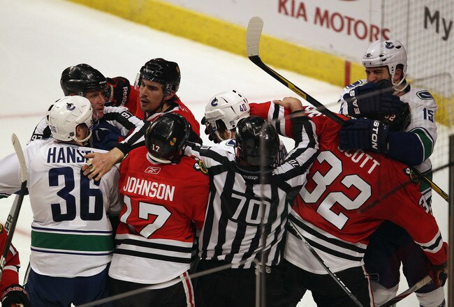 CHICAGO, IL - APRIL 19: Referees try to break up a fight between members of the Chicago Blackhawks including Ryan Johnson #17, Chris Campoli #14 and John Scott #32 with members of the Vancouver Canucks including Jannik Hansen #36, Maxim Lapierre #40 and Tanner Glass #15 in Game Four of the Western Conference Quarterfinals during the 2011 NHL Stanley Cup Playoffs at the United Center on April 19, 2011 in Chicago, Illinois. The Blackhawks defeated the Canucks 7-2. (Photo by Jonathan Daniel/Getty Images)