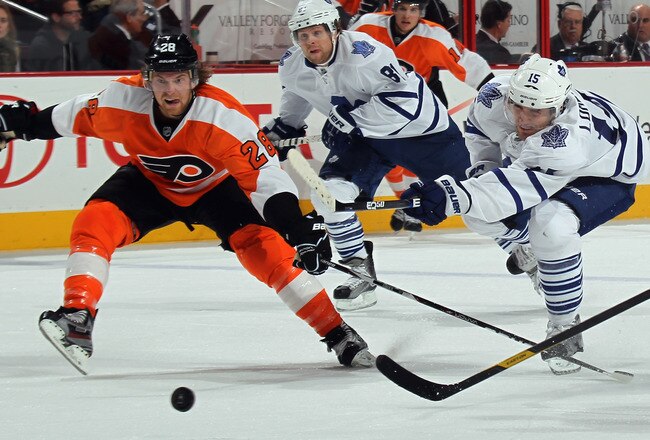 PHILADELPHIA, PA - OCTOBER 24: Matthew Lombardi #15 of the Toronto Maple Leafs shoots the puck as Claude Giroux #28 of the Philadelphia Flyers attempts to block the shot at Wells Fargo Center on October 24, 2011 in Philadelphia, Pennsylvania.  (Photo by Bruce Bennett/Getty Images)
