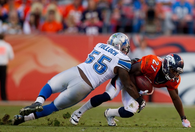 DENVER, CO - OCTOBER 30:  Running back Knowshon Moreno #27 of the Denver Broncos tries to escape the grasp of linebacker Stephen Tulloch #55 of the Detroit Lions at Sports Authority Field at Mile High on October 30, 2011 in Denver, Colorado. The Lions defeated the Broncos 45-10. (Photo by Justin Edmonds/Getty Images)