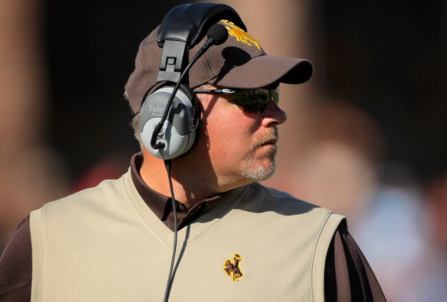 BOULDER, CO - SEPTEMBER 19:  Head coach Dave Christensen of the Wyoming Cowboys leads his team against the Colorado Buffaloes at Folsom Field on September 19, 2009 in Boulder, Colorado.  (Photo by Doug Pensinger/Getty Images)