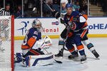 UNIONDALE, NY - OCTOBER 29: Rick DiPietro #39 and Travis Hamonic #3 of the New York Islanders defend against Ryane Clowe #29 of the San Jose Sharks at the Nassau Veterans Memorial Coliseum on October 29, 2011 in Uniondale, New York. The Sharks defeated the Islanders 3-2 in overtime. (Photo by Bruce Bennett/Getty Images)