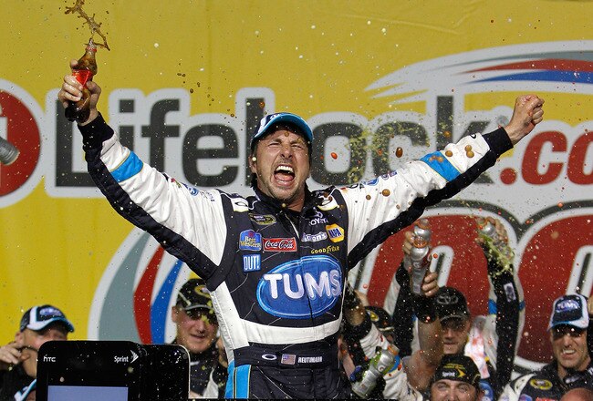 JOLIET, IL - JULY 10:  David Reutimann, driver of the #00 TUMS Toyota, celebrates in victory lane after he won the NASCAR Sprint Cup Series LIFELOCK.COM 400 at the Chicagoland Speedway on July 10, 2010 in Joliet, Illinois.  (Photo by Chris Trotman/Getty Images for NASCAR)