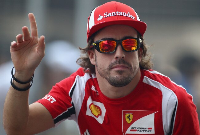 NOIDA, INDIA - OCTOBER 30:  Fernando Alonso of Spain and Ferrari attends the drivers parade before the Indian Formula One Grand Prix at the Buddh International Circuit on October 30, 2011 in Noida, India.  (Photo by Clive Mason/Getty Images)