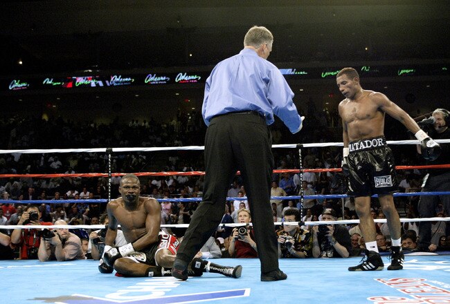 LAS VEGAS - JULY 12:  Ricardo Mayorga (R) watches as Vernon Forrest slips to the canvas while referee Jay Nady steps in during their WBA/WBC Welterweight Championship fight at the Orleans Arena on July 12, 2003 in Las Vegas, Nevada.  Mayorga (26-3-1) retained his WBA/WBC welterweight titles with a 12 round majority decision over Forrest (35-2-0).  (Photo by Jed Jacobsohn/Getty Images)
