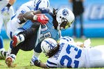 NASHVILLE, TN - OCTOBER 30:  Ernie Sims #55 and Terrence Johnson #23 of the Indianapolis Colts tackle Chris Johnson #28 of the Tennessee Titans for a loss during play at LP Field on October 30, 2011 in Nashville, Tennessee. The Titans won 27-10.  (Photo by Grant Halverson/Getty Images)