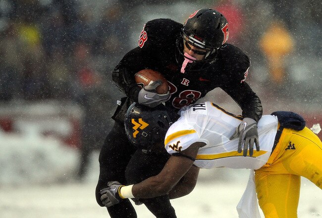 NEW BRUNSWICK, NJ - OCTOBER 29:  Keith Tandy #8 of the West Virginia Mountaineers tackles Joe Martinek #38 of the Rutgers Scarlet Knights at High Point Solutions Stadium on October 29, 2011 in New Brunswick, New Jersey.  (Photo by Patrick McDermott/Getty Images)