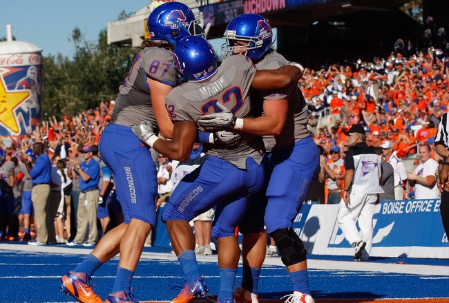 BOISE, ID - OCTOBER 22:  Gabe Linehan #87, Doug Martin #22, and Chandler Koch #88 of the Boise State Broncos celebrate Martin's touchdown against the Air Force Falcons at Bronco Stadium on October 22, 2011 in Boise, Idaho.  (Photo by Otto Kitsinger III/Getty Images)