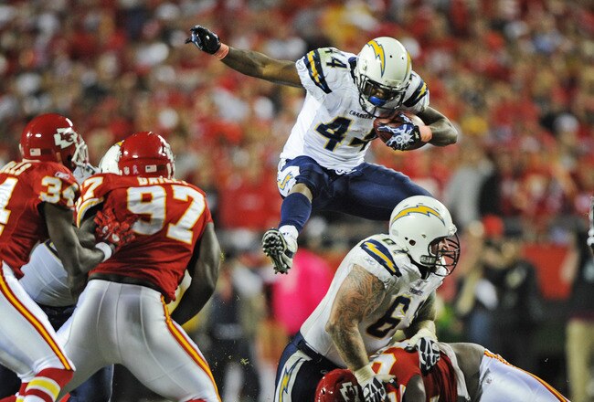 KANSAS CITY, MO - OCTOBER 31:  Running back Curtis Brinkley #44 of the San Diego Chargers leaps over teammate Nick Hardwick #61 for extra yardage against the Kansas City Chiefs during the fourth quarter on October 31, 2011 at Arrowhead Stadium in Kansas City, Missouri.  The Chiefs defeated the Chargers 23-20 in overtime.  (Photo by Peter Aiken/Getty Images)