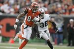 CINCINNATI - DECEMBER 10:  Wide receiver T.J. Houshmandzadeh #84 of the Cincinnati Bengals runs with the ball against defensive back Tyrone Poole #38 of the Oakland Raiders on December 10, 2006 at Paul Brown Stadium in Cincinnati, Ohio. The Bengals defeated the Raiders 27-10. (Photo by David Maxwell/Getty Images)