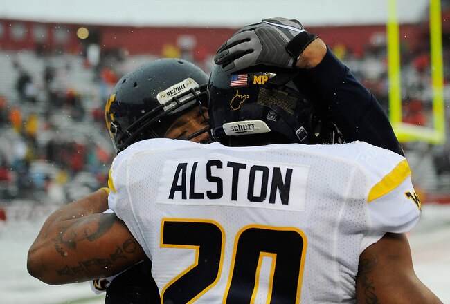 NEW BRUNSWICK, NJ - OCTOBER 29:  Shawne Alston #20 of the West Virginia Mountaineers celebrates with a teammate after scoring a touchdown against the Rutgers Scarlet Knights at High Point Solutions Stadium on October 29, 2011 in New Brunswick, New Jersey.  (Photo by Patrick McDermott/Getty Images)