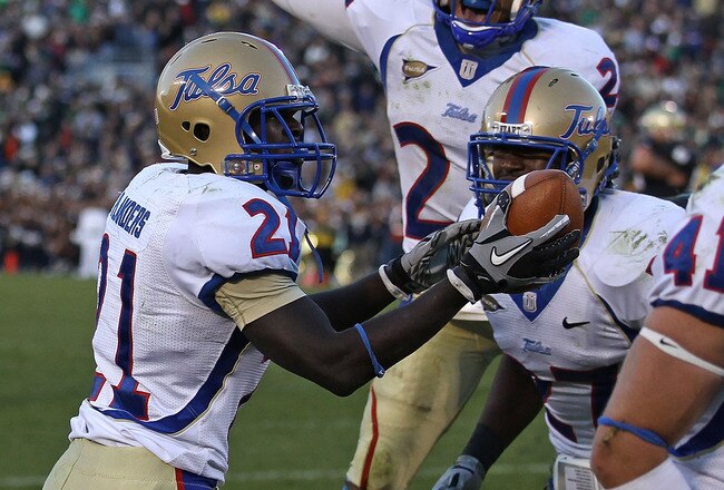 SOUTH BEND, IN - OCTOBER 30: John Flanders #21 of the Tulsa Golden Hurricane holds the ball after intercepting a pass in the end zone against the Notre Dame Fighting Irish as teammates Charles Davis #24 (center) and DeWitt Jennings #27 join the celebration at Notre Dame Stadium on October 30, 2010 in South Bend, Indiana. Tulsa defeated Notre Dame 28-27. (Photo by Jonathan Daniel/Getty Images)
