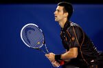 MELBOURNE, AUSTRALIA - JANUARY 17:  Novak Djkovic of Serbia waits to return serve in his first round match against Marcel Granollers of Spain during day one of the 2011 Australian Open at Melbourne Park on January 17, 2011 in Melbourne, Australia.  (Photo by Cameron Spencer/Getty Images)