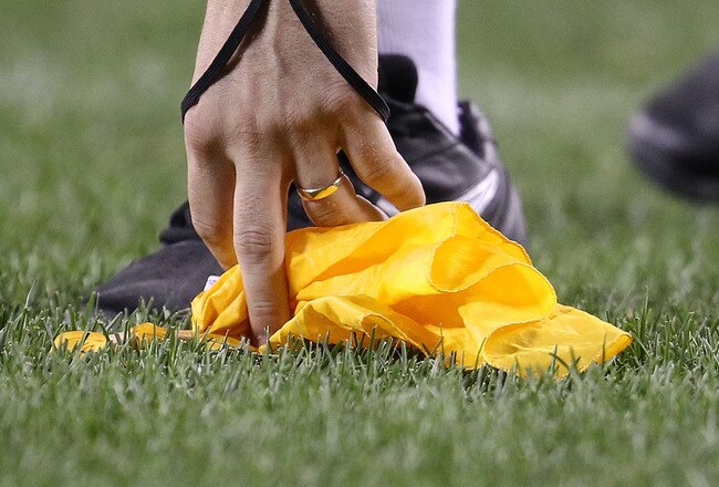 CHICAGO - AUGUST 28: A referee picks up a penalty flag during a preseason game between the Chicago Bears and the Arizona Cardinals during a preseason game at Soldier Field on August 28, 2010 in Chicago, Illinois. The Cardinals defeated the Bears 14-9. (Photo by Jonathan Daniel/Getty Images)