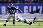 EAST RUTHERFORD, NJ - OCTOBER 30:   Ahmad Bradshaw #44 of the New York Giants breaks the tackle of Sean Smith #24 of the Miami Dolphins during the second quarter at MetLife Stadium on October 30, 2011 in East Rutherford, New Jersey.  (Photo by Patrick McDermott/Getty Images)