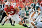 LINCOLN, NE - OCTOBER 29: Running back Rex Burkhead #22 of the Nebraska Cornhuskers gets tripped up by linebacker Marcus Rush #44 of the Michigan State Spartans during their game at Memorial Stadium October 29, 2011 in Lincoln, Nebraska. (Photo by Eric Francis/Getty Images)