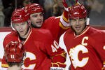 CALGARY, CANADA - APRIL 6:Jarome Iginla #12 of the Calgary Flames is congratulated by teammates Alex Tanguay #40 and Mark Giordano #5 on his hat trick goal against the Edmonton Oilers in third period NHL action on April 6, 2011 at the Scotiabank Saddledome in Calgary, Alberta, Canada. (Photo by Mike Ridewood/Getty Images)