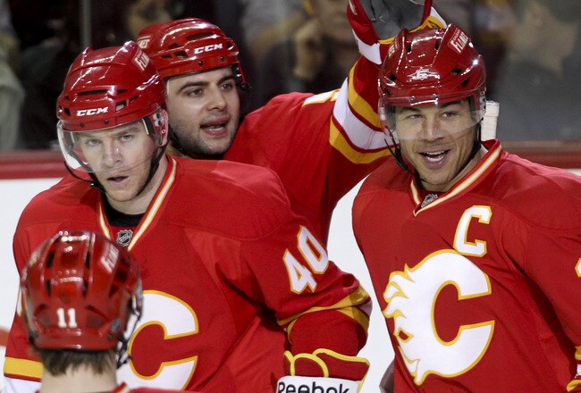 CALGARY, CANADA - APRIL 6:Jarome Iginla #12 of the Calgary Flames is congratulated by teammates Alex Tanguay #40 and Mark Giordano #5 on his hat trick goal against the Edmonton Oilers in third period NHL action on April 6, 2011 at the Scotiabank Saddledome in Calgary, Alberta, Canada. (Photo by Mike Ridewood/Getty Images)