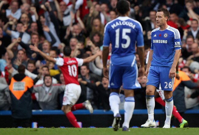 LONDON, ENGLAND - OCTOBER 29:  Robin van Persie of Arsenal celebrates scoring as John Terry of Chelsea reacts during the Barclays Premier League match between Chelsea and Arsenal at Stamford Bridge on October 29, 2011 in London, England.  (Photo by Clive Rose/Getty Images)