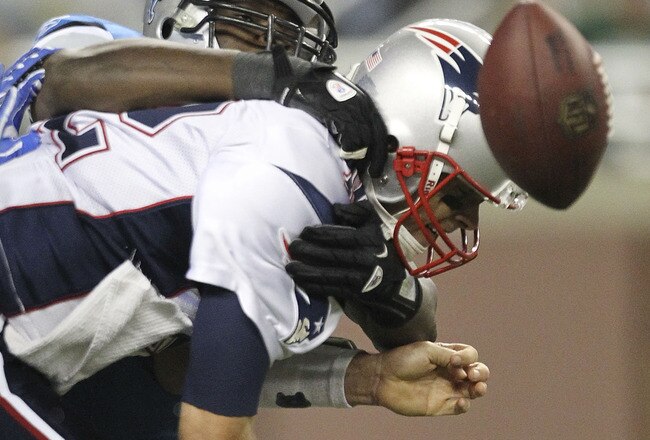 DETROIT - AUGUST 27: Cliff Avril #92 of the Detroit Lions sacks Tom Brady #12 of the New England Patriots during the first quarter of the game at Ford Field on August 27, 2011 in Detroit, Michigan.  (Photo by Leon Halip/Getty Images)