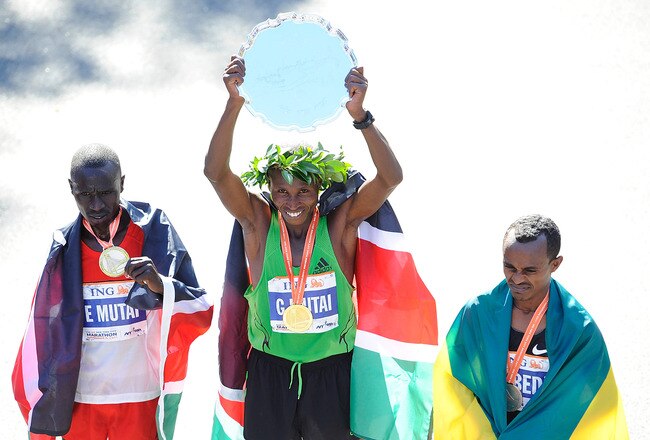 NEW YORK, NY - NOVEMBER 06:  Geoffrey Mutai of Kenya (C), Emmanuel Mutai of Kenya (L), and Tsegaye Kebede of Ethiopia (R) celebrate after the 42nd ING New York City Marathon in Central Park on November 6, 2011 in New York City.  (Photo by Patrick McDermott/Getty Images)