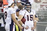 GLENDALE, AZ - DECEMBER 12:  Quarterbacks Brady Quinn #9 and Tim Tebow #15 of the Denver Broncos stand on the sideline during the NFL game against the Arizona Cardinals at the University of Phoenix Stadium on December 12, 2010 in Glendale, Arizona.   The Cardinals defeated the Broncos 43-13.  (Photo by Christian Petersen/Getty Images)