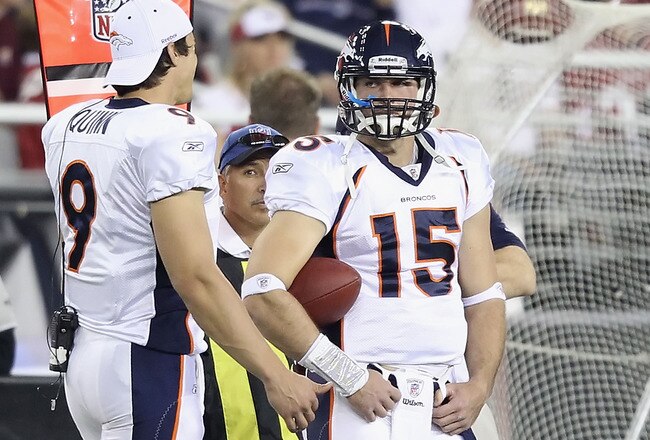 GLENDALE, AZ - DECEMBER 12:  Quarterbacks Brady Quinn #9 and Tim Tebow #15 of the Denver Broncos stand on the sideline during the NFL game against the Arizona Cardinals at the University of Phoenix Stadium on December 12, 2010 in Glendale, Arizona.   The Cardinals defeated the Broncos 43-13.  (Photo by Christian Petersen/Getty Images)