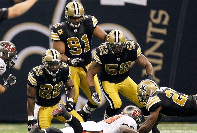 NEW ORLEANS, LA - NOVEMBER 06:  Tracy Porter #22 of the New Orleans Saints kneels just after tackling Mike Williams #19 of the Tampa Bay Buccaneers at Mercedes-Benz Superdome on November 6, 2011 in New Orleans, Louisiana.  Porter was carted off the field with a neck injury.  (Photo by Kevin C. Cox/Getty Images)