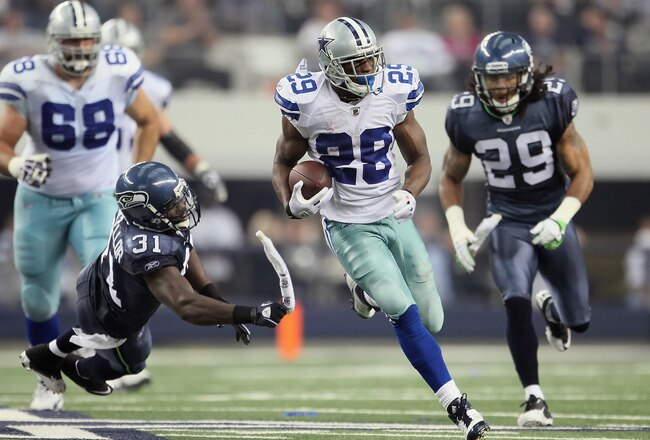ARLINGTON, TX - NOVEMBER 06:  Kam Chancellor #31 of the Seattle Seahawks grabs the towel of running back DeMarco Murray #29 of the Dallas Cowboys in the first half at Cowboys Stadium on November 6, 2011 in Arlington, Texas. The Cowboys defeated the Seahawks 23-13.  (Photo by Jeff Gross/Getty Images)