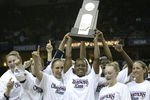 NEW ORLEANS - APRIL 6:  Ashley Battle #23 (C), Diana Taurasi #3 (L), and Maria Conlon #5 (R) of the University of Connecticut Huskies hold the NCAA National Championship trophy after defeating the Tennessee Lady Vols 70-61 in the National Championship game of the NCAA Women's Final Four Tournament at the New Orleans Arena on April 6, 2004 in New Orleans, Louisiana.  (Photo by Elsa/Getty Images)