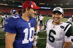 EAST RUTHERFORD, NJ - AUGUST 29:  Eli Manning #10 of the New York Giants talks with Mark Sanchez #6 of the New York Jets after their game on August 29, 2009 at Giants Stadium in East Rutherford, New Jersey.  (Photo by Jim McIsaac/Getty Images)
