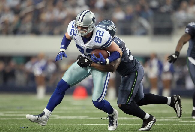 ARLINGTON, TX - NOVEMBER 06:  Jason Witten #82 of the Dallas Cowboys is brought down by David Hawthorne #57 of the Seattle Seahawks after a reception in the first half at Cowboys Stadium on November 6, 2011 in Arlington, Texas. The Cowboys defeated the Seahawks 23-13.  (Photo by Jeff Gross/Getty Images)