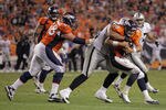 DENVER, CO - SEPTEMBER 12:  Quarterback Kyle Orton #8 of the Denver Broncos is sacked by defensive tackle  Richard Seymour #92 of the Oakland Raiders in the third quarterat Sports Authority Field at Mile High on September 12, 2011 in Denver, Colorado. The Raiders defeated the Broncos 23-20.  (Photo by Doug Pensinger/Getty Images)