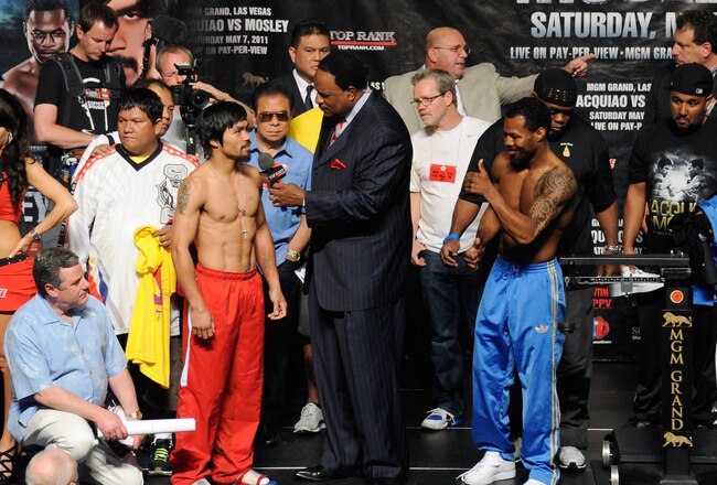LAS VEGAS, NV - MAY 06:  Sportscaster James Brown (C) interviews boxers Manny Pacquiao (L) and Shane Mosley (R) during the official weigh-in for their bout at the MGM Grand Garden Arena May 6, 2011 in Las Vegas, Nevada. Pacquiao will defend his WBO welterweight title against Mosley on May 7, 2011 in Las Vegas, Nevada.  (Photo by Ethan Miller/Getty Images)