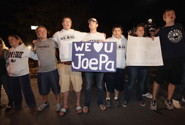 STATE COLLEGE, PA - NOVEMBER 08: Penn State University students sing outside of the home of head football coach Joe Paterno during November 8, 2011 in State College, Pennsylvania. Behind Paterno is his son Scott Paterno  (Photo by Rob Carr/Getty Images)