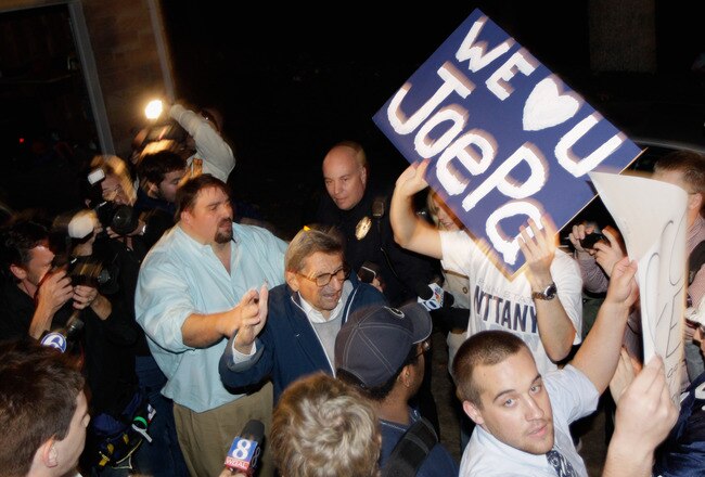 STATE COLLEGE, PA - NOVEMBER 08:  Penn State University head football coach Joe Paterno (C) is greeted by a large group of students after arriving at his home, November 8, 2011 in State College, Pennsylvania. Behind Paterno is his son Scott Paterno  (Photo by Rob Carr/Getty Images)