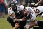 OAKLAND, CA - NOVEMBER 06:  Elvis Dumervil #92 and Jason Hunter #52 of the Denver Broncos sack Carson Palmer #3 of the Oakland Raiders at O.co Coliseum on November 6, 2011 in Oakland, California.  (Photo by Ezra Shaw/Getty Images)