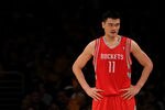 LOS ANGELES, CA - OCTOBER 26:  Yao Ming #11 of the Houston Rockets looks on during their opening night game against the Los Angeles Lakers at Staples Center on October 26, 2010 in Los Angeles, California. NOTE TO USER: User expressly acknowledges and agrees that, by downloading and or using this photograph, User is consenting to the terms and conditions of the Getty Images License Agreement.  (Photo by Jeff Gross/Getty Images)