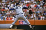 ANAHEIM, CA - 1989:  Tommy John #25 of the New York Yankees pitches during a 1989 season game against the California Angels at Anaheim Stadium in Anaheim, California.  (Photo by Stephen Dunn/Getty Images)