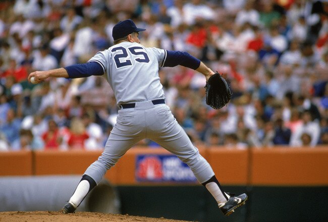 ANAHEIM, CA - 1989:  Tommy John #25 of the New York Yankees pitches during a 1989 season game against the California Angels at Anaheim Stadium in Anaheim, California.  (Photo by Stephen Dunn/Getty Images)