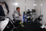 SAO PAULO, BRAZIL - OCTOBER 18:  Jenson Button of Great Britain and Brawn GP makes a phone call in his team garage as he celebrates clinching the F1 World Drivers Championship during the Brazilian Formula One Grand Prix at the Interlagos Circuit on October 18, 2009 in Sao Paulo, Brazil.  (Photo by Mark Thompson/Getty Images)