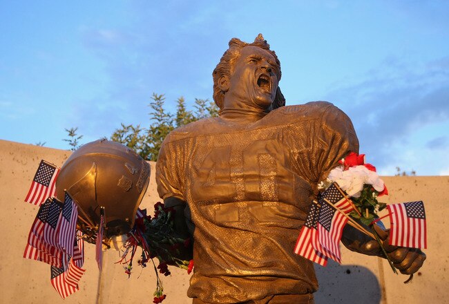 GLENDALE, AZ - SEPTEMBER 11:  Fans adorn the Pat Tillman statue with American flags in honor of the 10 year anniversary of the 9/11 attacks following the NFL season opening game between the Carolina Panthers and the Arizona Cardinals at the University of Phoenix Stadium on September 11, 2011 in Glendale, Arizona.  (Photo by Christian Petersen/Getty Images)