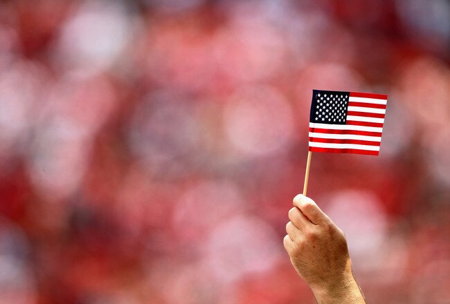 SAN FRANCISCO, CA - SEPTEMBER 11:  A fan holds an American flag during the singing of the National Anthem before the San Francisco 49ers' season opener against the Seattle Seahawks at Candlestick Park on September 11, 2011 in San Francisco, California.  (Photo by Ezra Shaw/Getty Images)