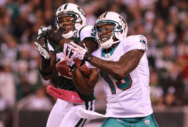 Antonio Cromartie #31 of the New York Jets battles for the ball against Brandon Marshall #19 of the Miami Dolphins during the third quarter at MetLife Stadium on October 17, 2011 in East Rutherford, New Jersey.